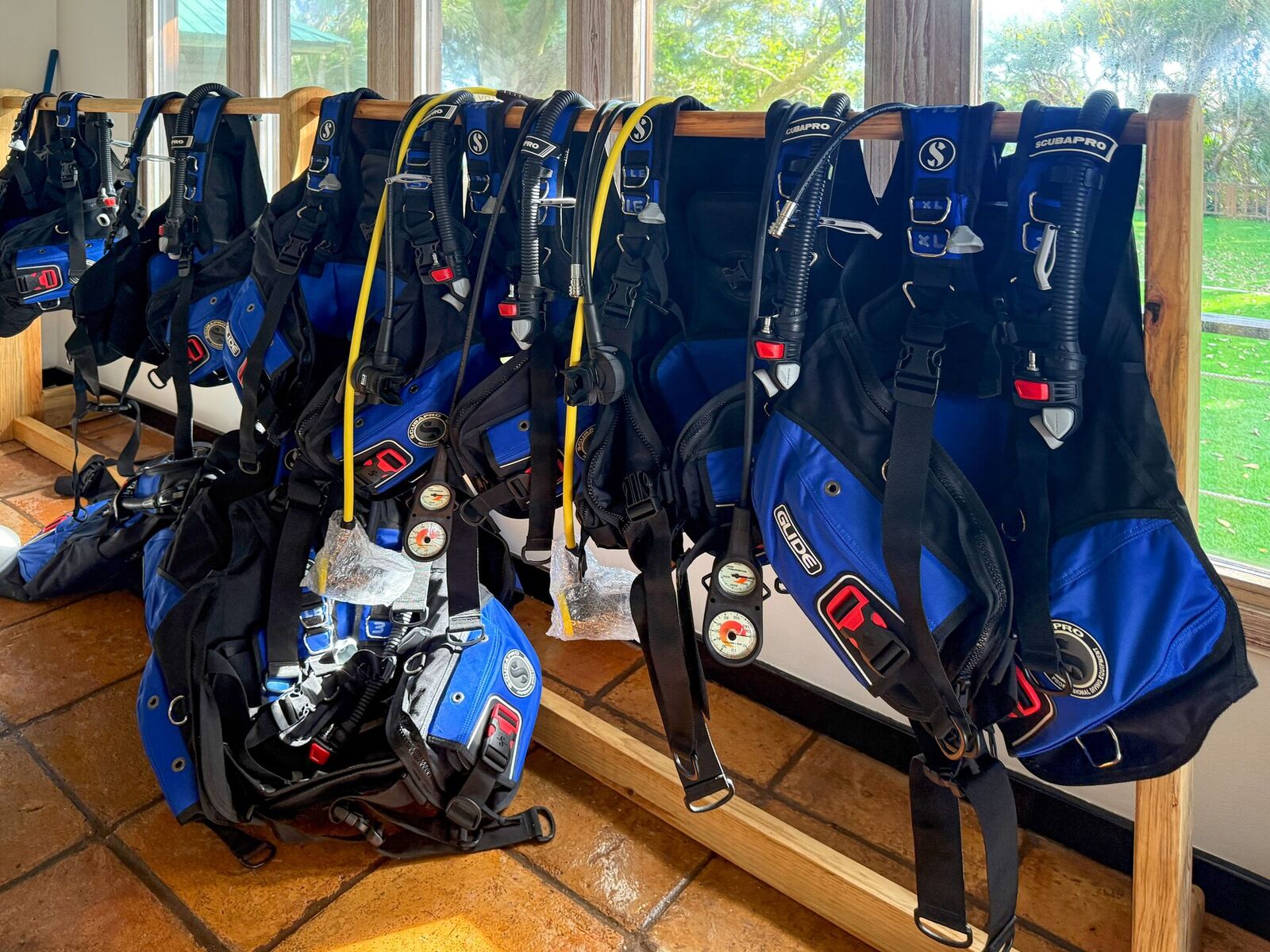 Rack of diving regulators and buoyancy vests ready for a reef excursion