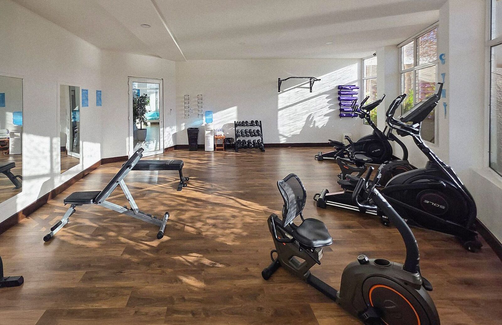 Hotel gym with treadmills, an exercise bike, and free weights